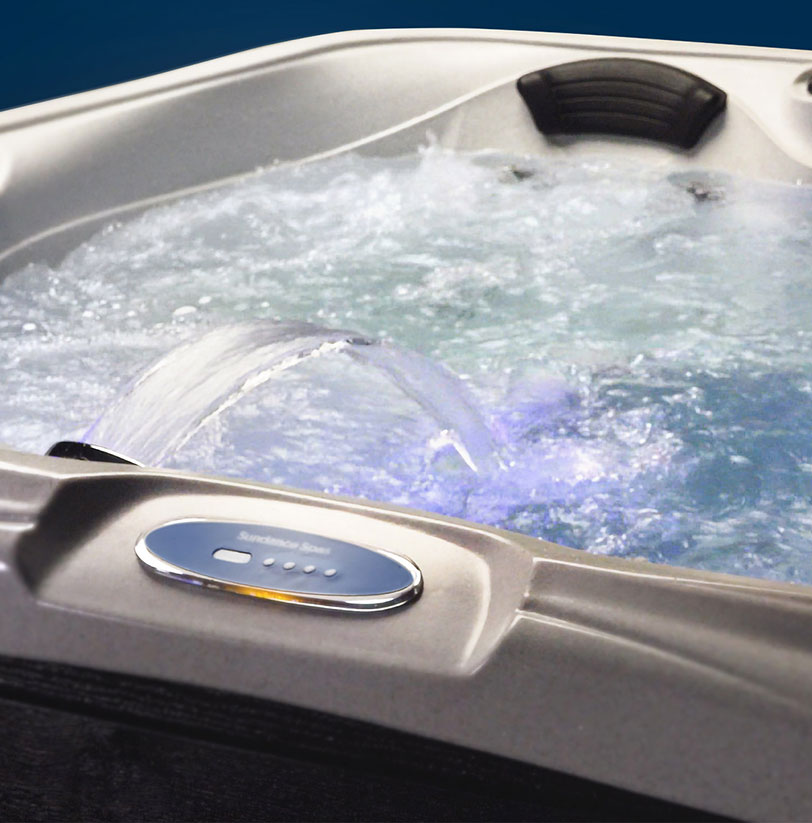 Close-up of bubbling hot tub water with moving water elements and LED purple-tinted lights, showcasing hot tubs for sale in New Fairfield, CT.